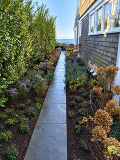 Stone garden walk beside a coastal home